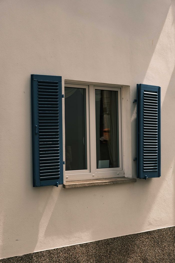 Blue shuttered window on a historic building facade in Rüdesheim am Rhein, capturing the essence of traditional German architecture.